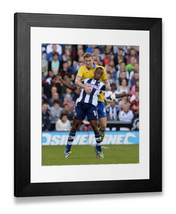 Framed Print : Per Mertesacker vs. Saido Berahino: A Battle in the Premier League (West Bromwich Albion vs. Arsenal, 2013) Framed Print : Per Mertesacker vs. Saido Berahino: A Battle in the Premier League (West Bromwich Albion vs. Arsenal, 2013)