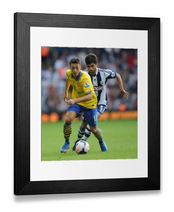 Framed Print : Mesut Ozil vs. Claudio Yacob: A Battle in the Premier League