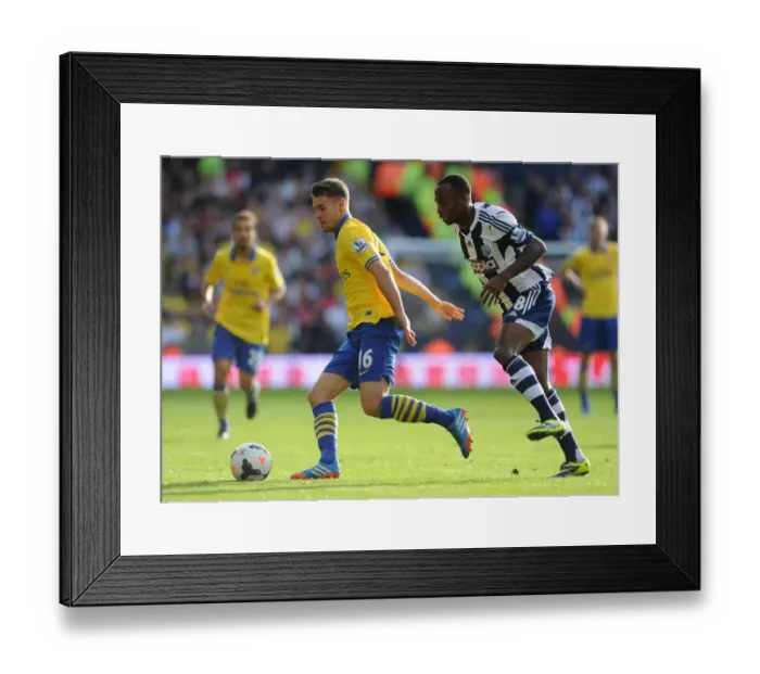 Framed Print : Arsenal's Aaron Ramsey Faces Off Against Saido Berahino in Premier League Clash (West Bromwich Albion vs Arsenal, 2013-14) Framed Print : Arsenal's Aaron Ramsey Faces Off Against Saido Berahino in Premier League Clash (West Bromwich Albion vs Arsenal, 2013-14)