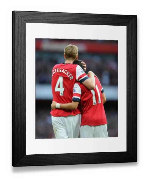 Framed Print : Arsenal's Unstoppable Duo: Ozil and Mertesacker Celebrate Victory Over Norwich City, 2013-14