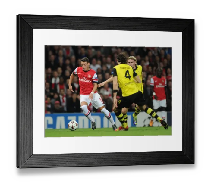 Framed Print : Mesut Ozil Outmaneuvers Neven Subotic and Marcel Schmelzer in Arsenal vs. Borussia Dortmund UEFA Champions League Clash Framed Print : Mesut Ozil Outmaneuvers Neven Subotic and Marcel Schmelzer in Arsenal vs. Borussia Dortmund UEFA Champions League Clash