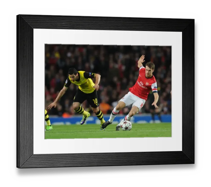 Framed Print : Arsenal's Aaron Ramsey Outmaneuvers Borussia Dortmund's Henrikh Mkhitaryan in 2013-14 Champions League Clash