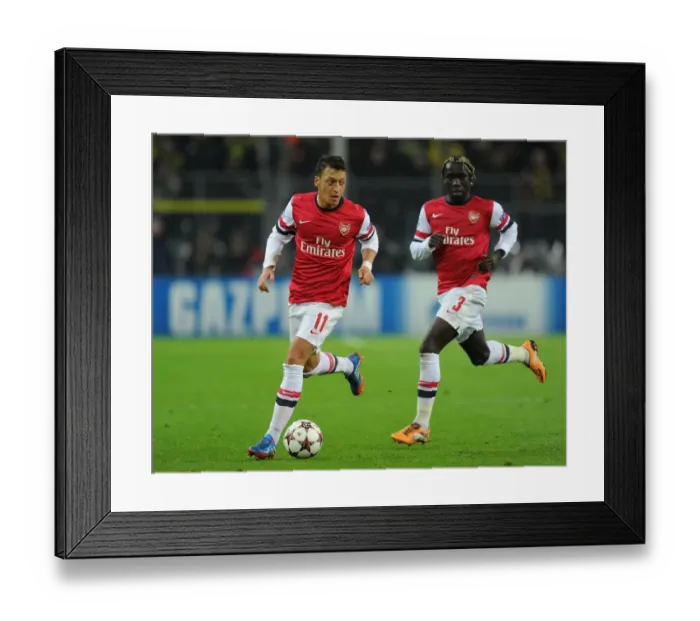 Framed Print : Mesut Ozil and Bacary Sagna of Arsenal Facing Off Against Borussia Dortmund in the 2013-14 UEFA Champions League Framed Print : Mesut Ozil and Bacary Sagna of Arsenal Facing Off Against Borussia Dortmund in the 2013-14 UEFA Champions League