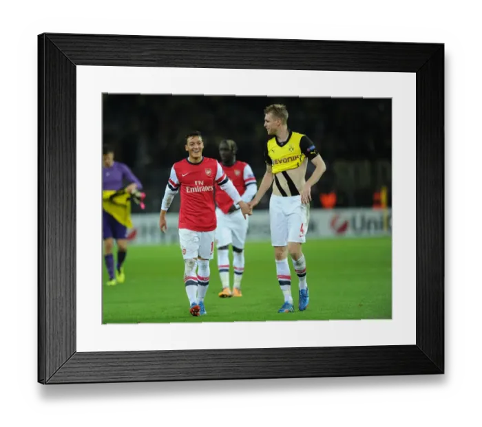 Framed Print : Mesut Ozil and Per Mertesacker Celebrate Arsenal's Victory over Borussia Dortmund in the UEFA Champions League