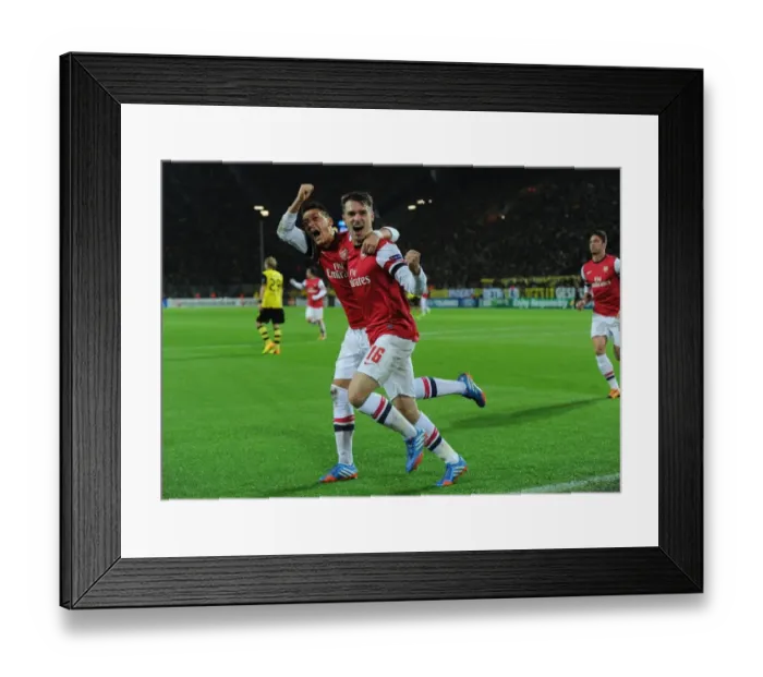 Framed Print : Unforgettable: Ramsey and Ozil's Euphoric Goal Celebration at Borussia Dortmund, Arsenal in the UEFA Champions League (2013-14)