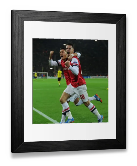 Framed Print : Unforgettable Goal Celebration: Ramsey and Ozil's Strike for Arsenal at Borussia Dortmund, UEFA Champions League (2013-14)