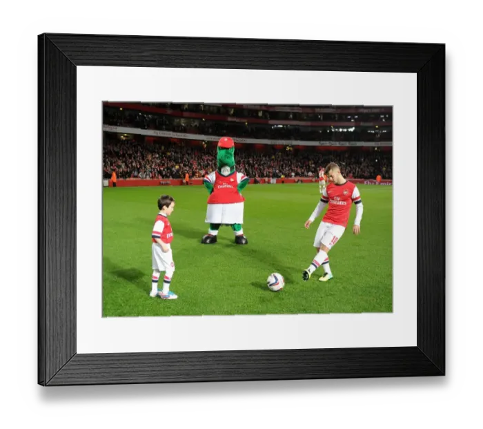 Framed Print : Arsenal mascot kicks a ball with Jack Wilshere (Arsenal) before the match. Arsenal 0: 2 Chelsea