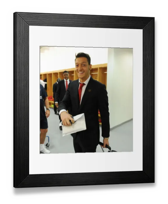 Framed Print : Mesut Ozil Arrives at Arsenal Changing Room Before Arsenal vs Liverpool (2013-14)
