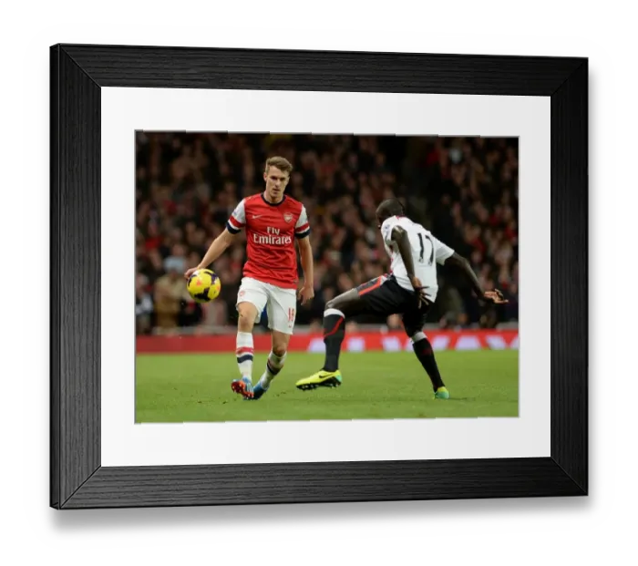 Framed Print : Aaron Ramsey (Arsenal) Mamadou Sakho (Liverpool). Arsenal 2: 0 Arsenal. Barclays Premier League