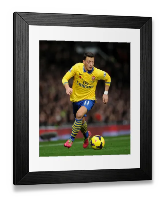 Framed Print : Clash of the Titans: Mesut Ozil Goes Head-to-Head with Manchester United (2013-14)