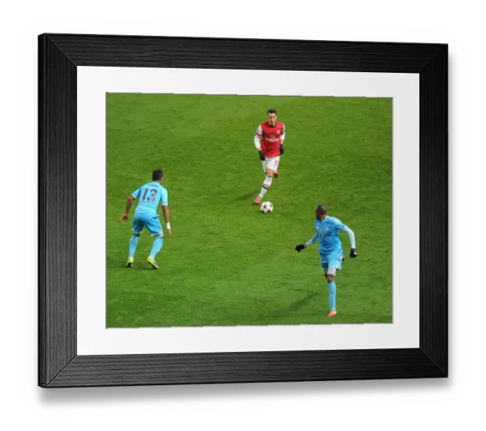 Framed Print : Mesut Ozil vs. Mario Lemina and Kassim Abdallah: Intense Battle at Arsenal v Marseille, UEFA Champions League (2013-14)