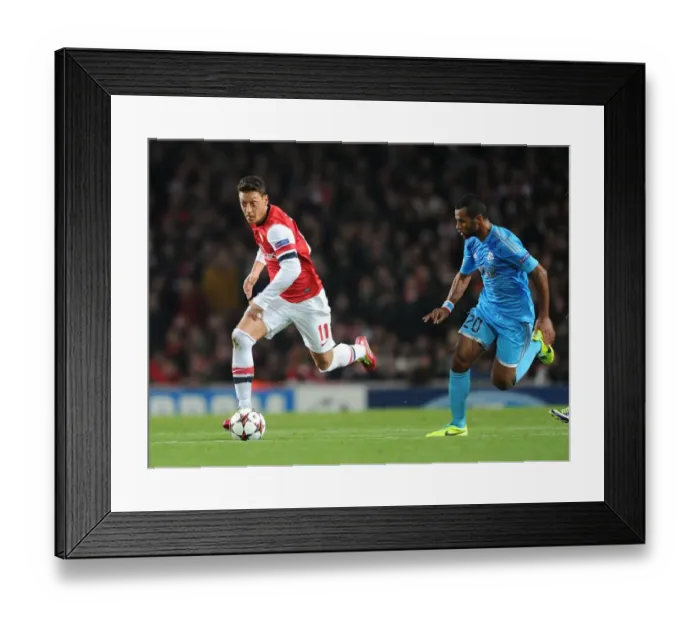 Framed Print : Mesut Ozil vs Alaixys Romao: Clash of Midfield Maestros in Arsenal vs Marseille UCL Showdown Framed Print : Mesut Ozil vs Alaixys Romao: Clash of Midfield Maestros in Arsenal vs Marseille UCL Showdown