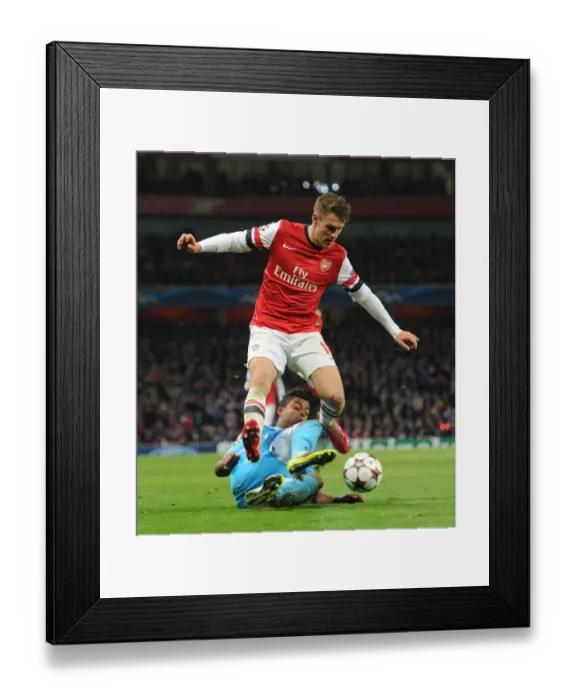 Framed Print : Arsenal's Aaron Ramsey Leaps Past Marseille's Mario Lemina in Champions League Clash