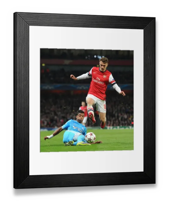 Framed Print : Arsenal's Aaron Ramsey Leaps Past Mario Lemina in Champions League Clash