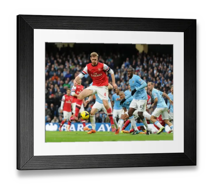 Framed Print : Per Mertesacker (Arsenal) Yaya Toure (Man City). Manchester City 6: 3 Arsenal. Barclays Framed Print : Per Mertesacker (Arsenal) Yaya Toure (Man City). Manchester City 6: 3 Arsenal. Barclays