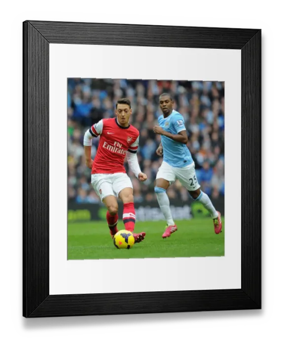 Framed Print : Mesut Ozil vs Fernandinho: Intense Midfield Battle at Manchester City vs Arsenal (2013-14)