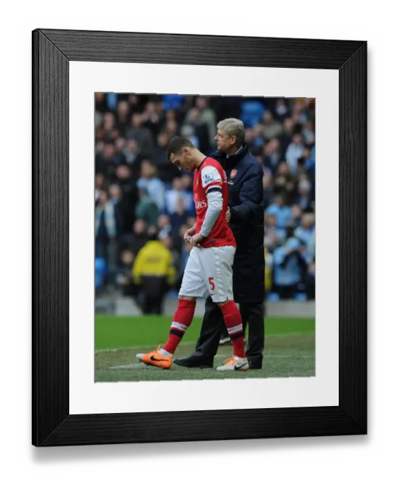 Framed Print : Arsene Wenger Consoles Sub Thomas Vermaelen during Manchester City vs. Arsenal (2013-14) Framed Print : Arsene Wenger Consoles Sub Thomas Vermaelen during Manchester City vs. Arsenal (2013-14)