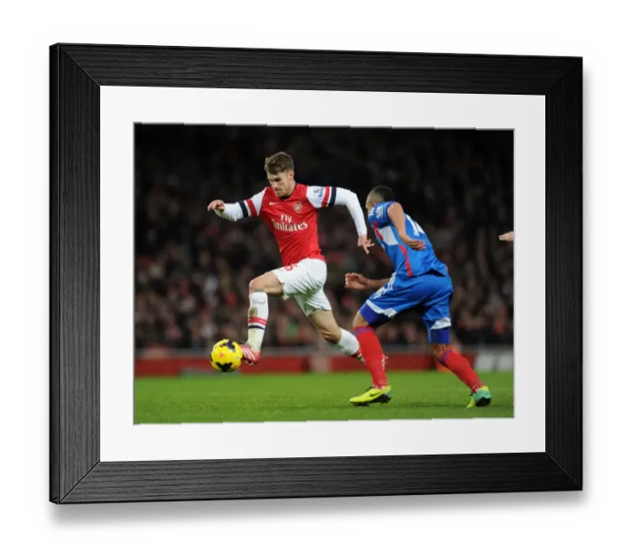 Framed Print : Arsenal's Aaron Ramsey Faces Off Against Hull City's Jake Livermore in Premier League Clash Framed Print : Arsenal's Aaron Ramsey Faces Off Against Hull City's Jake Livermore in Premier League Clash