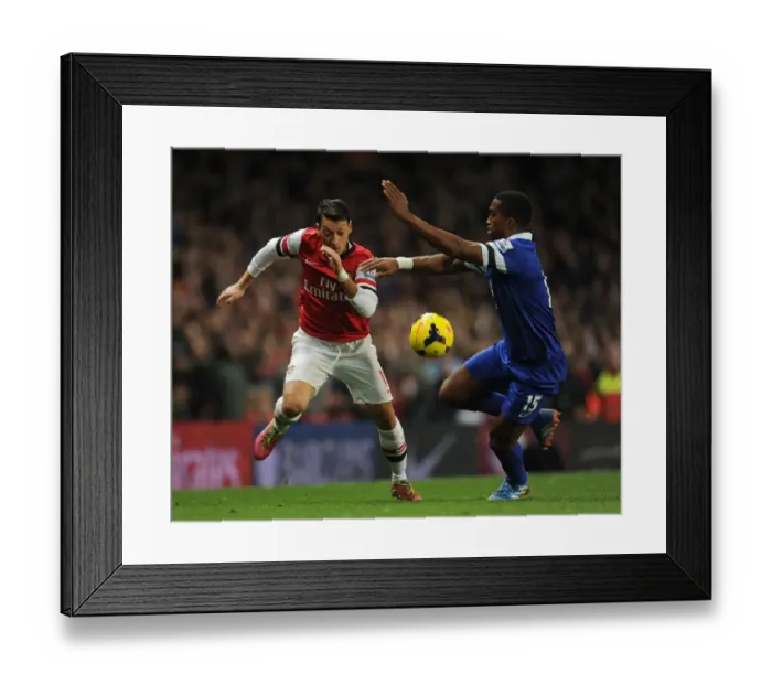 Framed Print : Mesut Ozil vs. Sylvain Distin: Arsenal vs. Everton, Premier League Showdown (2013-14)