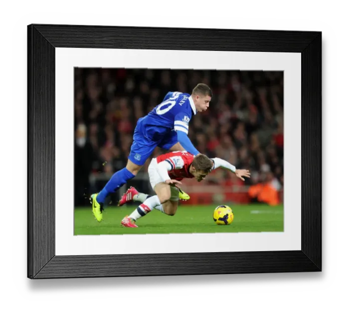 Framed Print : Arsenal's Aaron Ramsey Fouls by Everton's Ross Barkley in Premier League Clash (2013-14)
