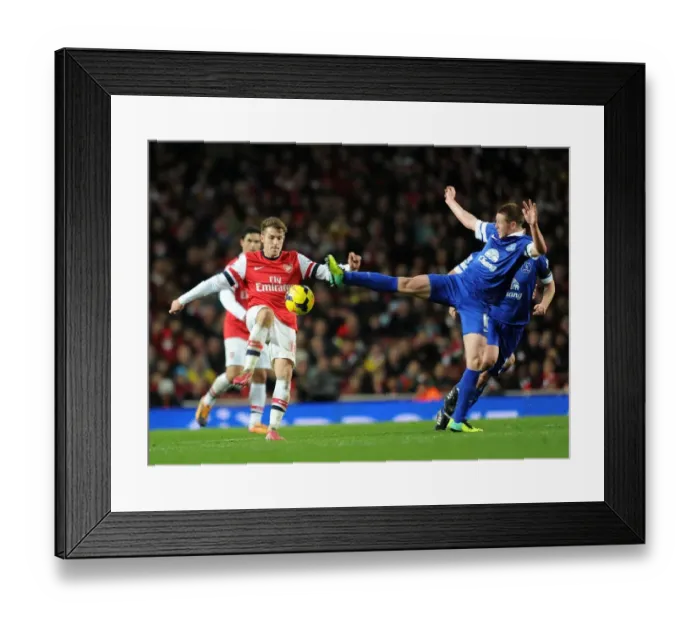 Framed Print : Arsenal's Aaron Ramsey Fouls by Everton's James McCarthy during Premier League Clash (2013-14) Framed Print : Arsenal's Aaron Ramsey Fouls by Everton's James McCarthy during Premier League Clash (2013-14)