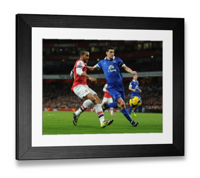 Framed Print : Intense Rivalry: Walcott vs. Barry in Arsenal v Everton Premier League Clash Framed Print : Intense Rivalry: Walcott vs. Barry in Arsenal v Everton Premier League Clash