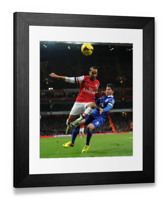 Framed Print : Arsenal's Theo Walcott Faces Off Against Everton's Bryan Oviedo in Premier League Clash Framed Print : Arsenal's Theo Walcott Faces Off Against Everton's Bryan Oviedo in Premier League Clash
