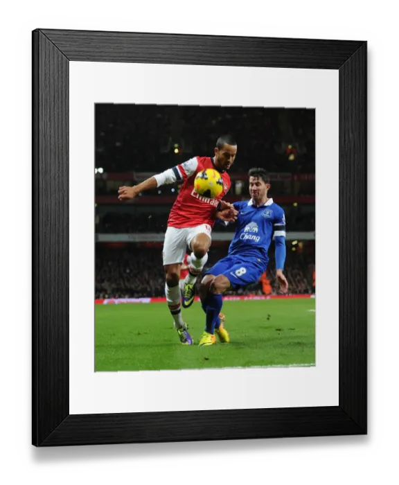 Framed Print : Theo Walcott (Arsenal) Bryan Oviedo (Everton). Arsenal 1: 1 Everton. Barclays Premier League