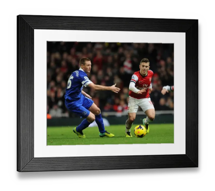 Framed Print : Intense Rivalry: Wilshere vs. McCarthy - Arsenal's Battle Against Everton (2013-14)