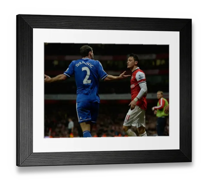 Framed Print : Mesut Ozil and Branislav Ivanovic: A Battle of Midfield Masters at the Emirates Stadium (Arsenal v Chelsea 2013-14)