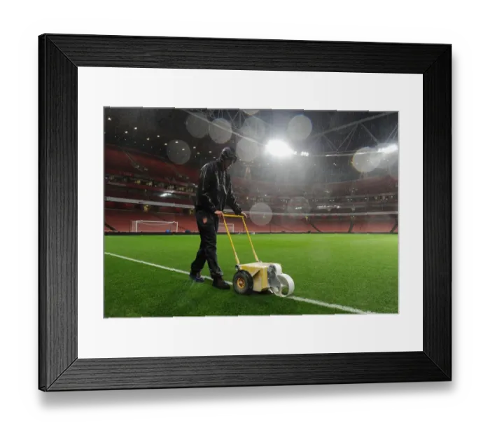 Framed Print : Arsenal's Groundsman Braves the Rain to Prepare for Arsenal v Chelsea Showdown Framed Print : Arsenal's Groundsman Braves the Rain to Prepare for Arsenal v Chelsea Showdown