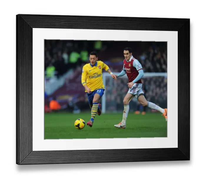 Framed Print : Mesut Ozil Outmaneuvers Joey O'Brien: A Pivotal Moment in the West Ham United vs. Arsenal Premier League Clash (December 2013) Framed Print : Mesut Ozil Outmaneuvers Joey O'Brien: A Pivotal Moment in the West Ham United vs. Arsenal Premier League Clash (December 2013)