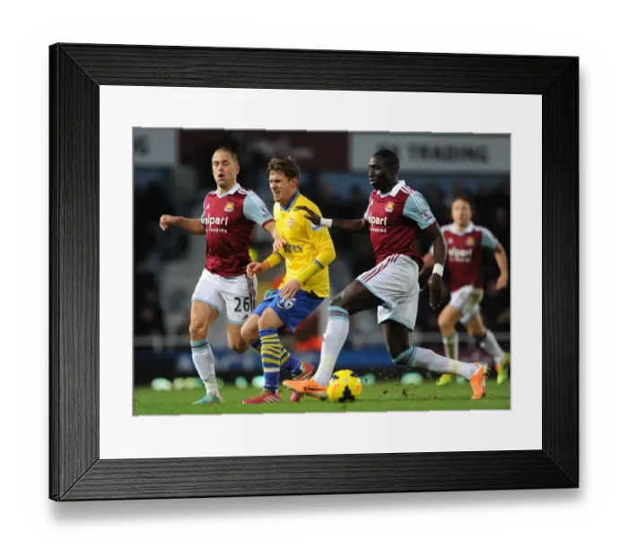 Framed Print : Aaron Ramsey's Injury Drama: Joe Cole and Mohamed Diame Challenge the Arsenal Star in West Ham vs Arsenal (2013-14)
