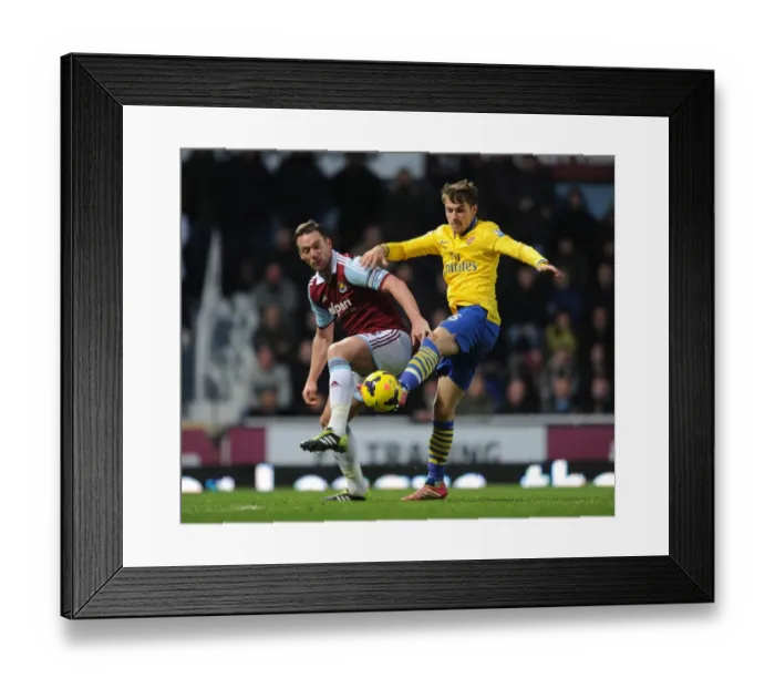 Framed Print : Ramsey vs. Nolan: A Battle of Strength and Skill in the Arsenal vs. West Ham Premier League Clash