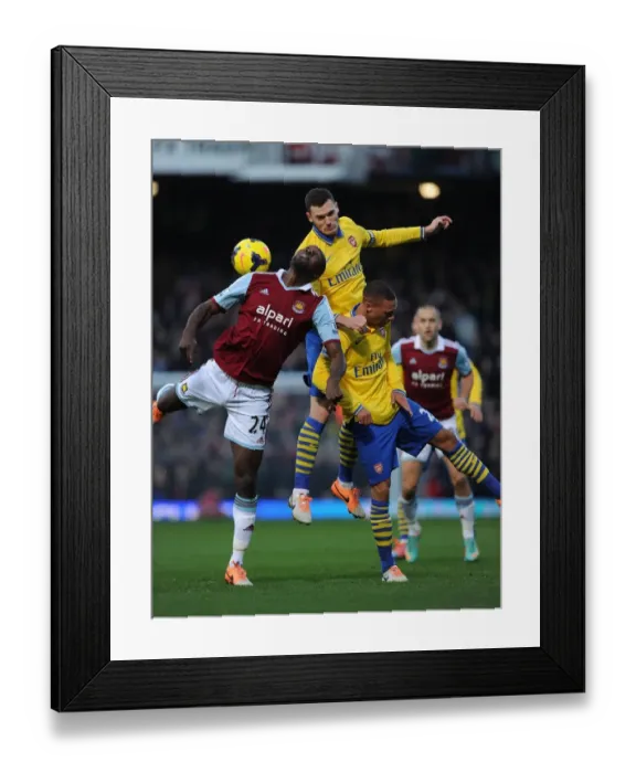 Framed Print : Arsenal's Vermaelen and Gibbs Clash with West Ham's Cole in Premier League Battle