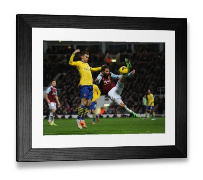 Framed Print : Arsenal's Vermaelen Clashes with West Ham's Rat in Premier League Showdown