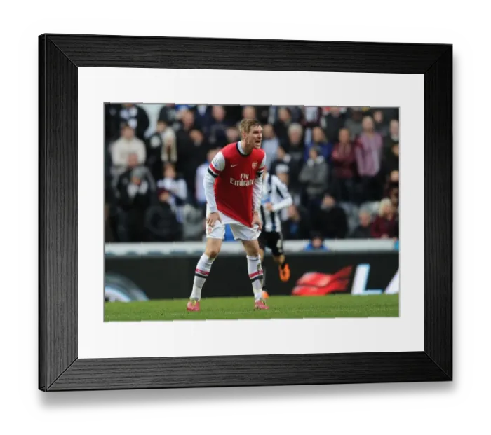 Framed Print : Per Mertesacker Focuses in Newcastle United vs Arsenal Premier League Clash (2013-14)