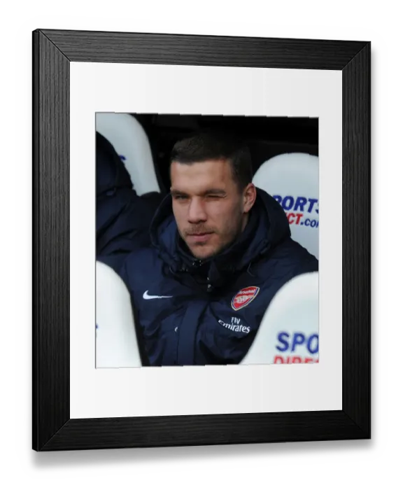 Framed Print : Lukas Podolski: Ready to Sub in for Arsenal against Newcastle United (Newcastle United v Arsenal 2013-14)