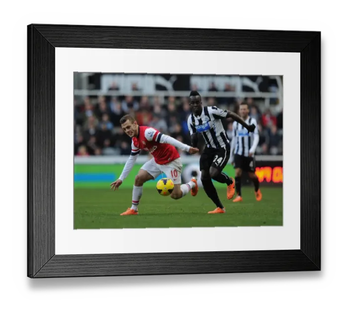 Framed Print : Jack Wilshere vs. Cheick Tiote: Battle in the Midfield - Newcastle United vs. Arsenal (2013-14) Framed Print : Jack Wilshere vs. Cheick Tiote: Battle in the Midfield - Newcastle United vs. Arsenal (2013-14)