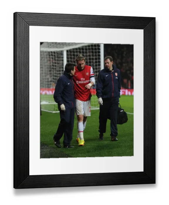 Framed Print : Arsenal's Injured Nicklas Bendtner Receives Treatment from Medical Team during Arsenal v Cardiff City
