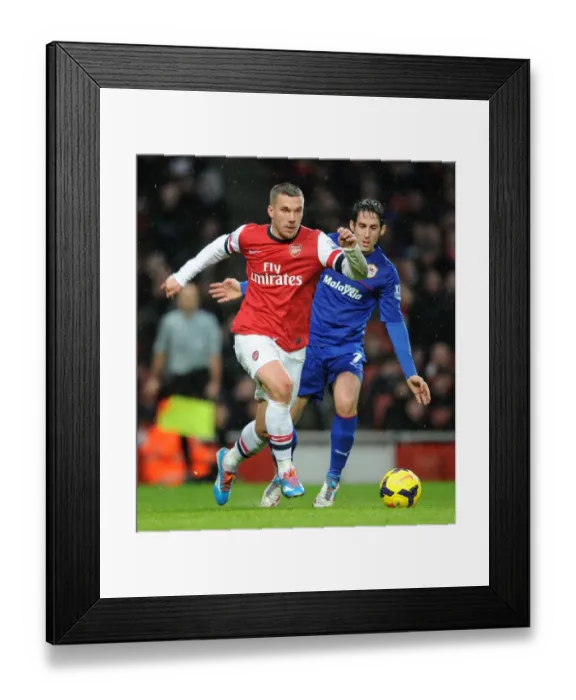 Framed Print : Intense Face-Off: Podolski vs. Whittingham - Arsenal's Lukas Podolski and Cardiff's Peter Whittingham Lock Horns in Premier League Clash