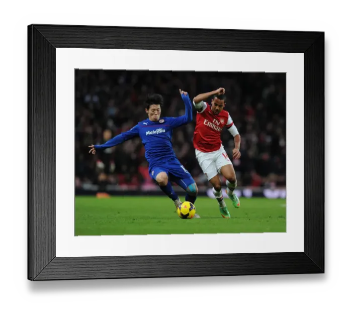 Framed Print : Theo Walcott vs. Bo-Kyung Kim: Intense Clash at Arsenal vs. Cardiff (Premier League, 2013-14) Framed Print : Theo Walcott vs. Bo-Kyung Kim: Intense Clash at Arsenal vs. Cardiff (Premier League, 2013-14)