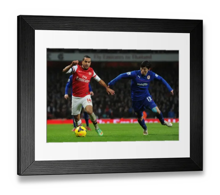 Framed Print : Theo Walcott vs. Kim Bo-Kyung: A Battle at the Emirates - Arsenal v Cardiff City, Premier League Framed Print : Theo Walcott vs. Kim Bo-Kyung: A Battle at the Emirates - Arsenal v Cardiff City, Premier League