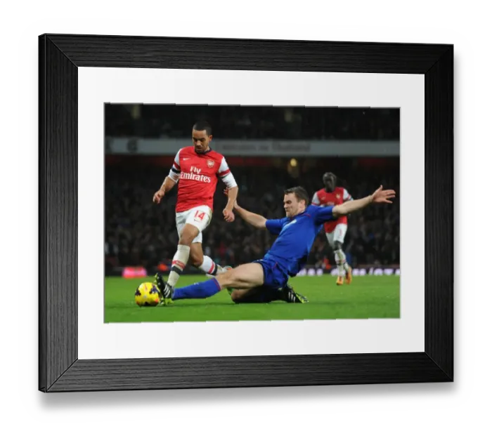 Framed Print : Arsenal vs. Cardiff: Walcott vs. Turner - Intense Battle in the Premier League
