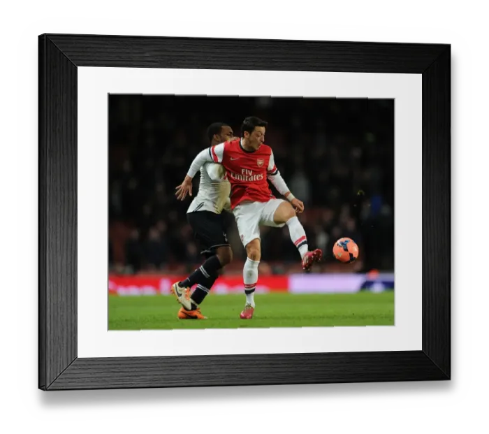Framed Print : Mesut Ozil vs. Danny Rose: Intense Battle at the Emirates - Arsenal vs. Tottenham FA Cup Clash, 2014