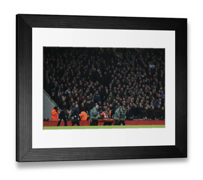Framed Print : Theo Walcott's Injury Marred by Abuse from Tottenham Fans during Arsenal v Tottenham FA Cup Match