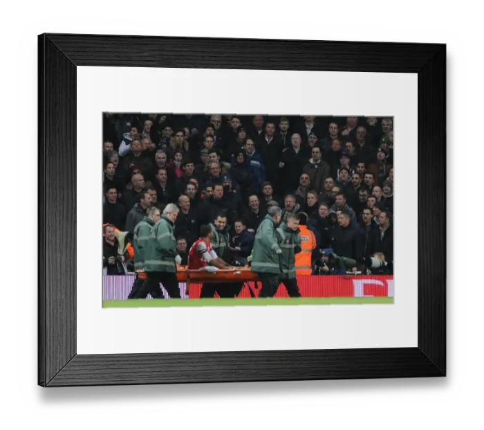 Framed Print : Theo Walcott's Injury Sparks Controversial Abuse from Tottenham Fans during Arsenal v Tottenham FA Cup Match