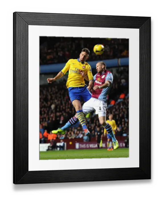 Framed Print : Arsenal's Olivier Giroud Heads Past Aston Villa's Ronald Vlaar in Premier League Clash Framed Print : Arsenal's Olivier Giroud Heads Past Aston Villa's Ronald Vlaar in Premier League Clash