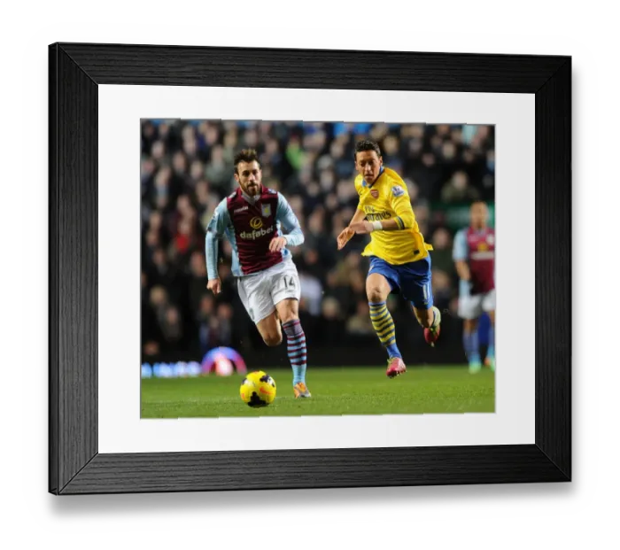 Framed Print : Mesut Ozil Outruns Antonio Luna: Aston Villa vs. Arsenal, Premier League 2013-14