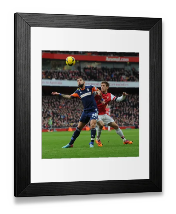 Framed Print : Monreal Stands Firm Against Dejagah: Arsenal vs Fulham, Premier League 2013-14